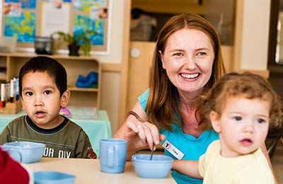 YMCA child care teacher with students