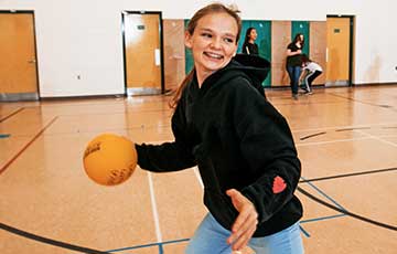 Teenage girl playing basketball at the YMCA