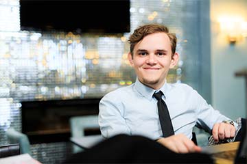 Young teen in suit working