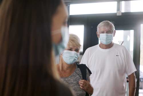 People wearing masks entering YMCA