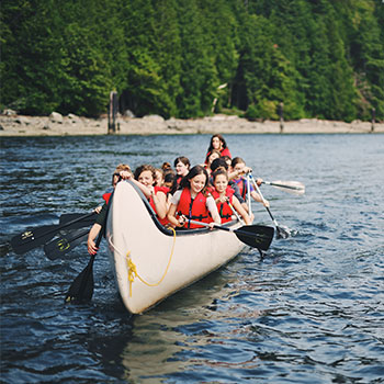 Camp kids in large canoe