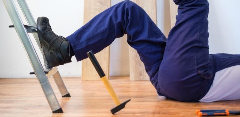 person laying on floor after falling off ladder