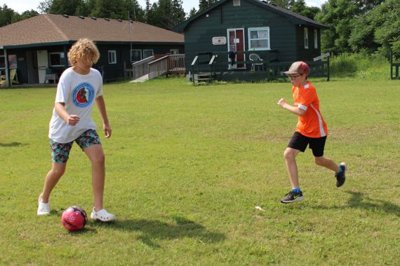 two boys playing soccer at Camp Presquile