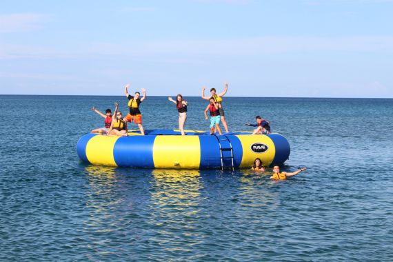 Group of kids playing on water trampoline at Camp Presqu'ile